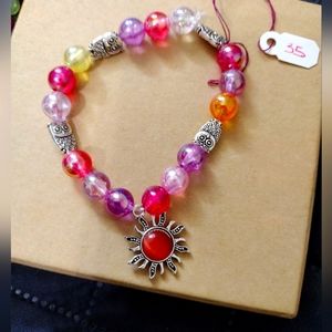 Artemis's Gems custom-made beaded bracelet with metal sun charm and owls rainbow